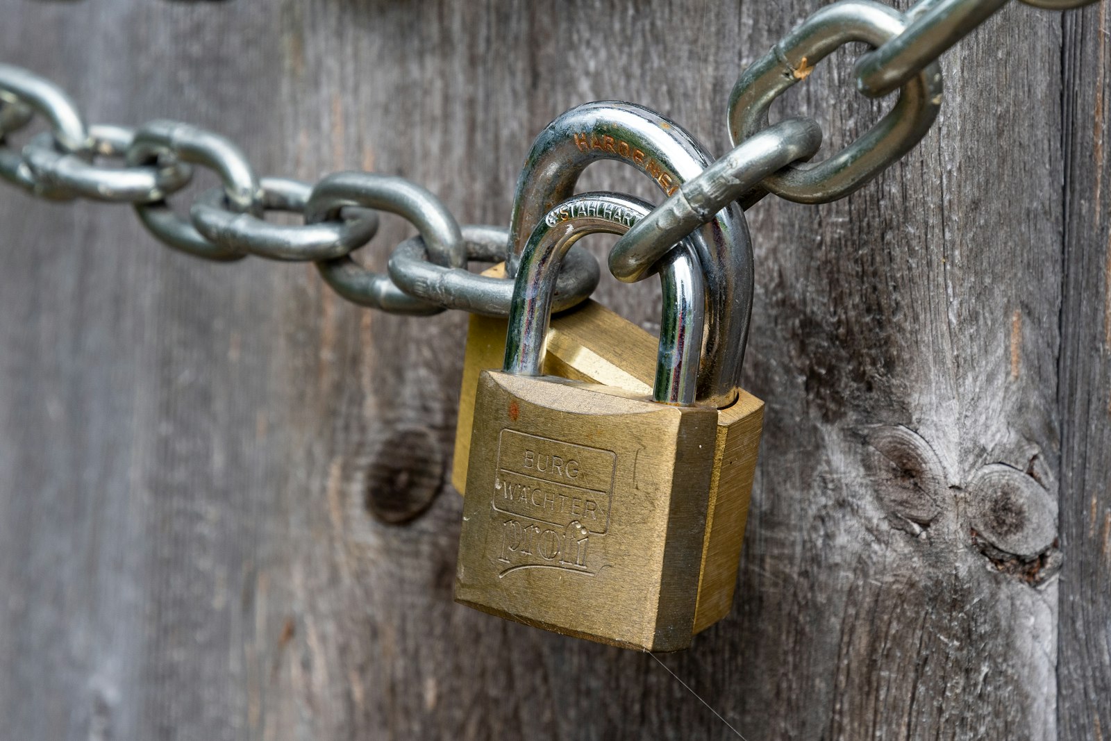 Brown padlock on brown wooden fence