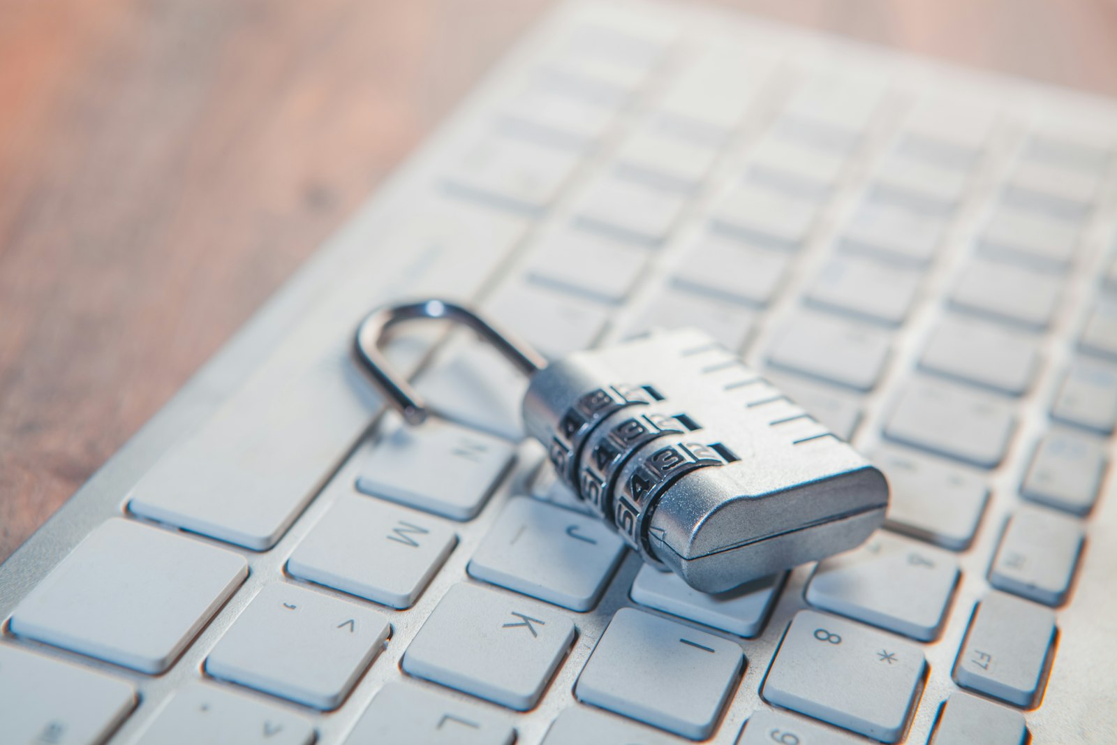 A combination lock rests on a computer keyboard