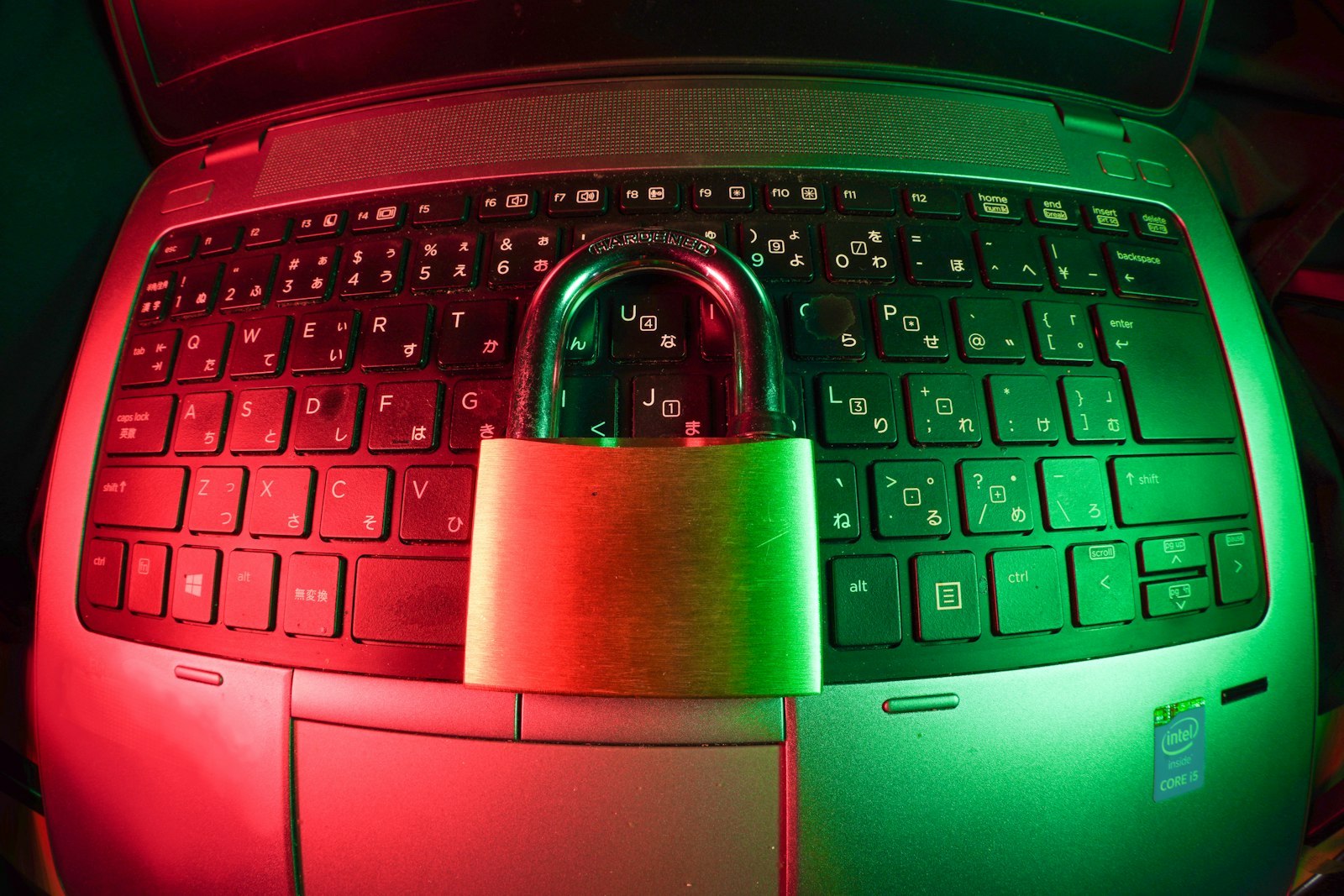Pink and silver padlock on black computer keyboard
