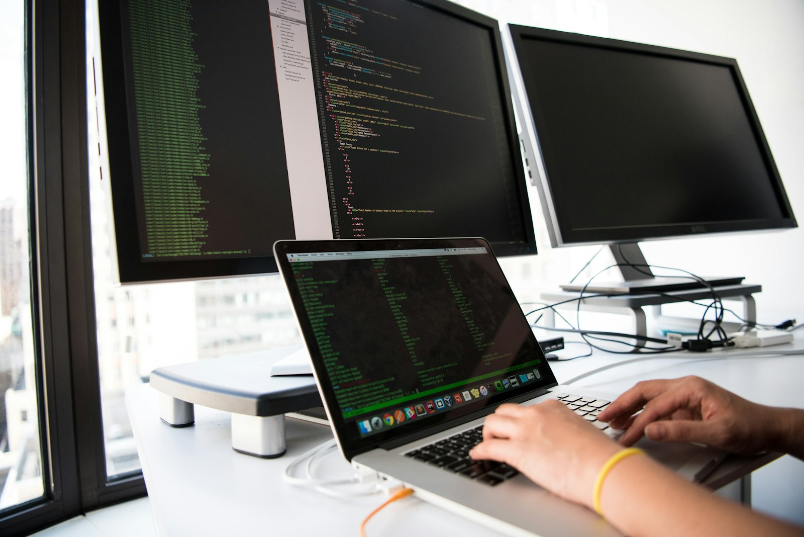 Shallow focus photo of person using MacBook