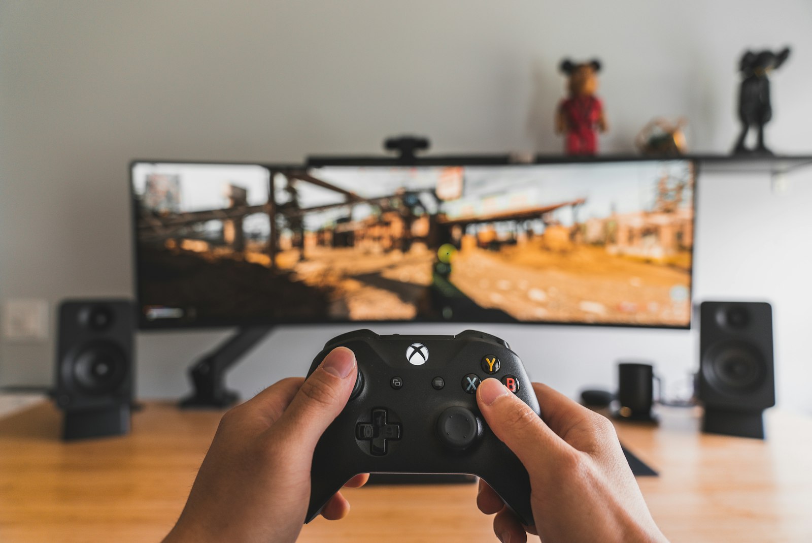 Person holding black game controller