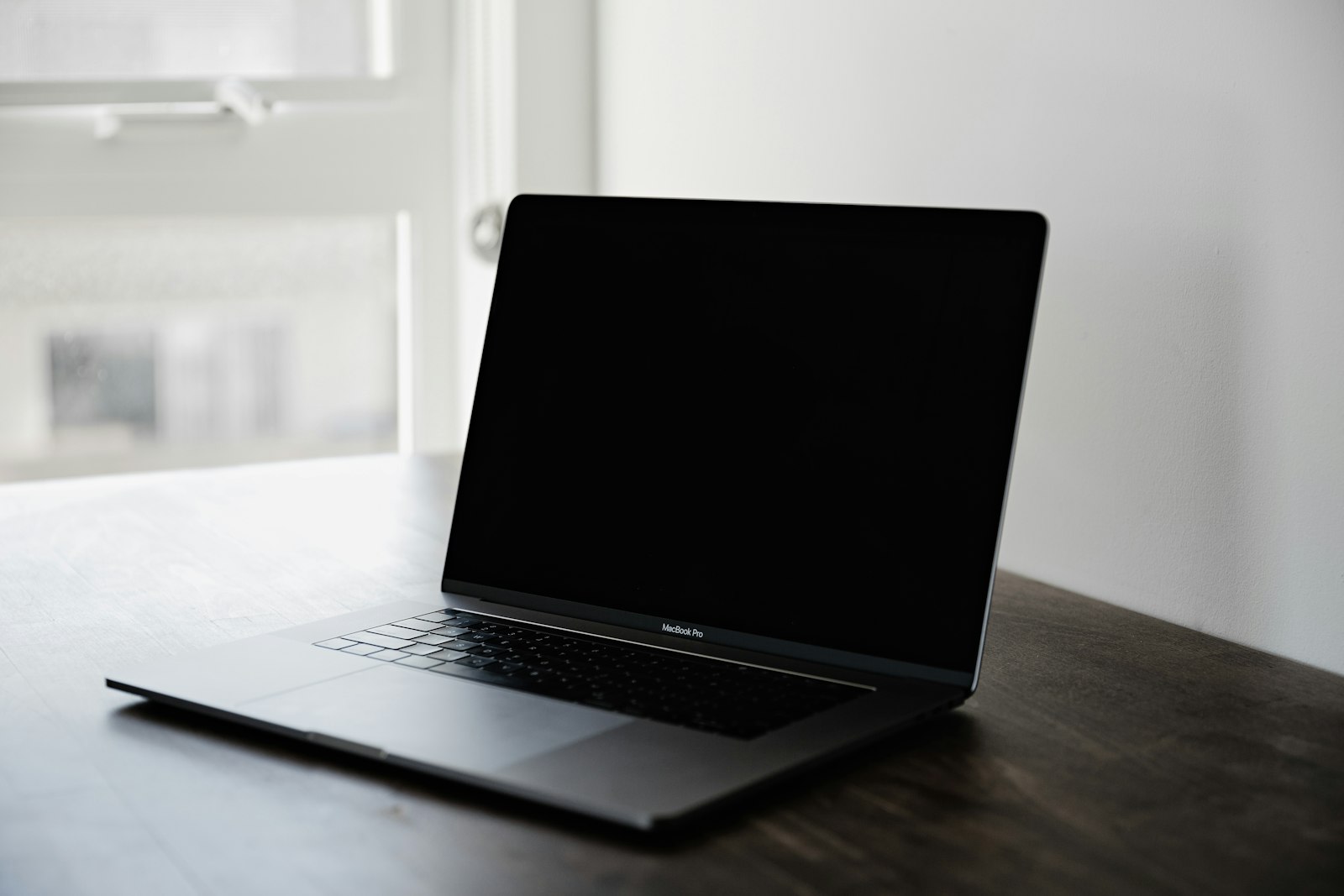 Photo of black MacBook Pro on table