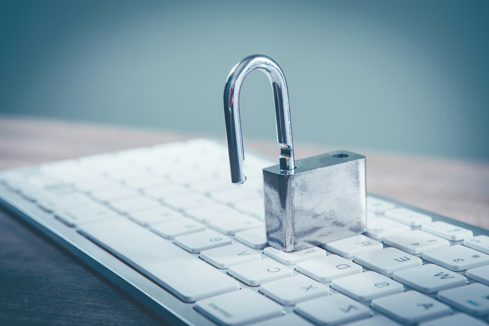 A padlock sitting on top of a computer keyboard