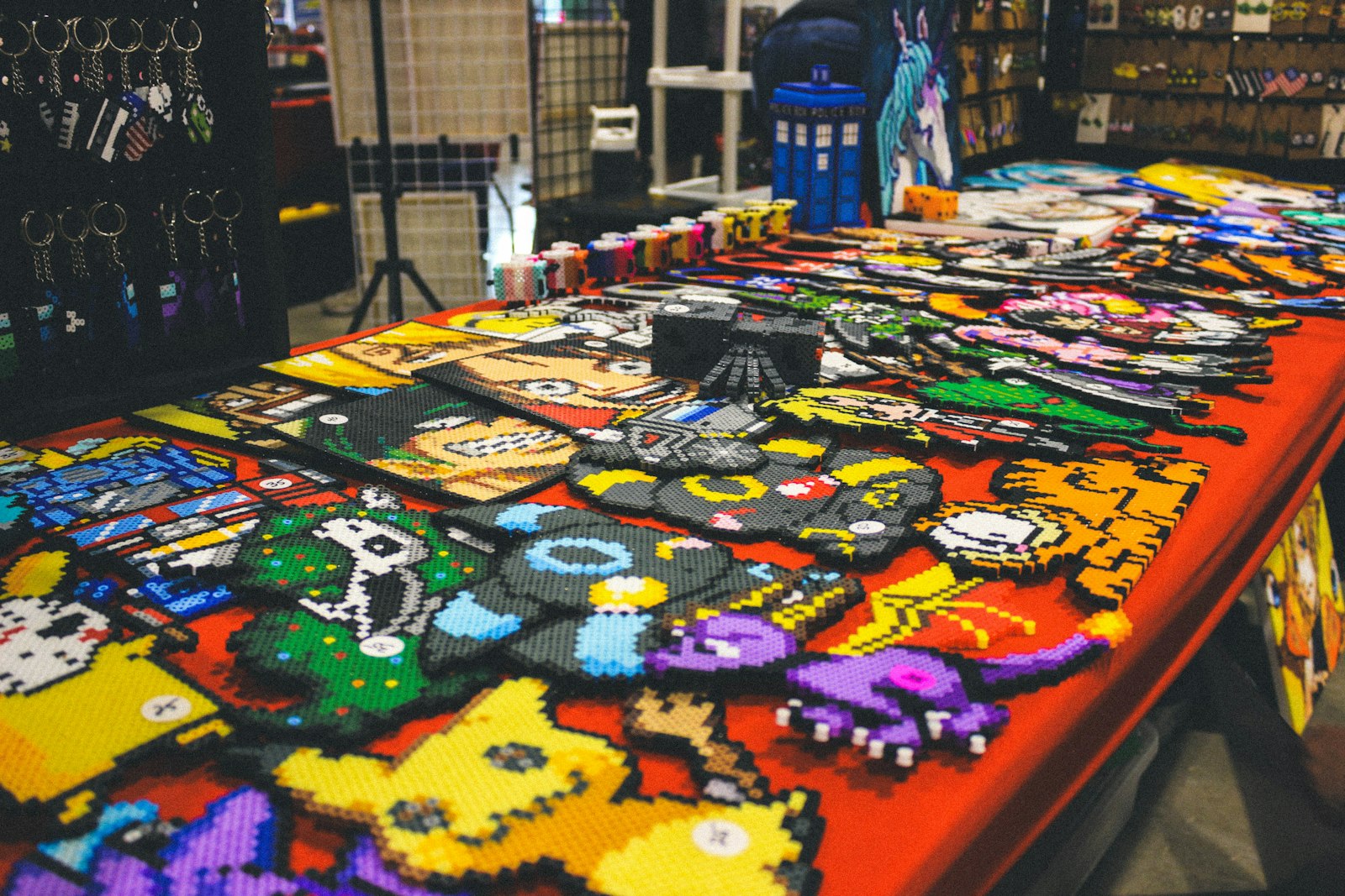 A table filled with colorful pixel art characters and crafts.