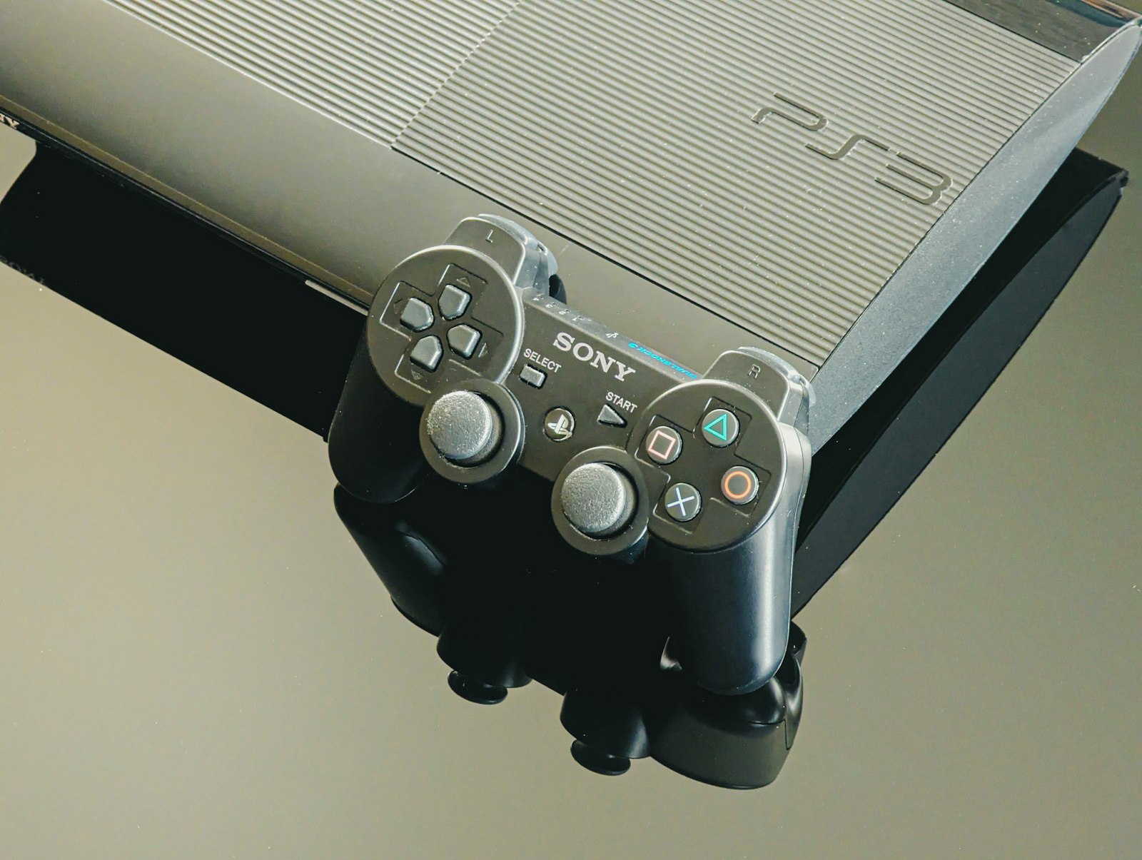 A playstation 3 console and its controller.