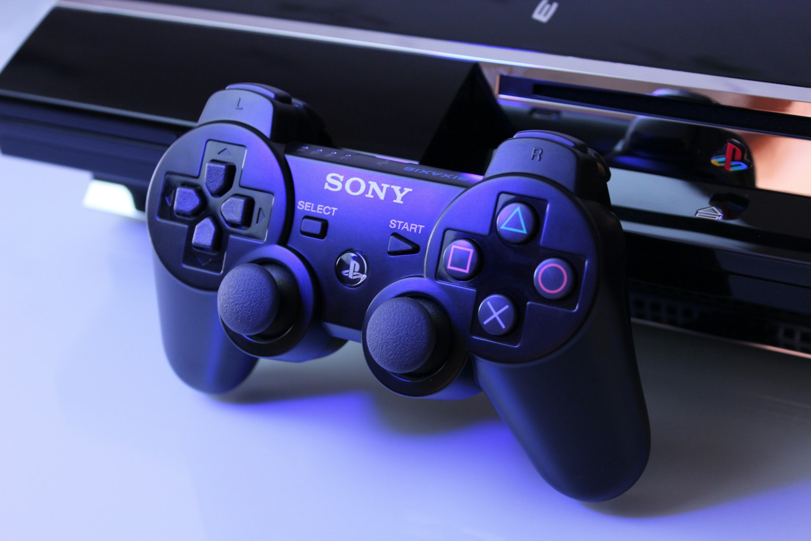 Black Sony PS2 controller on white surface