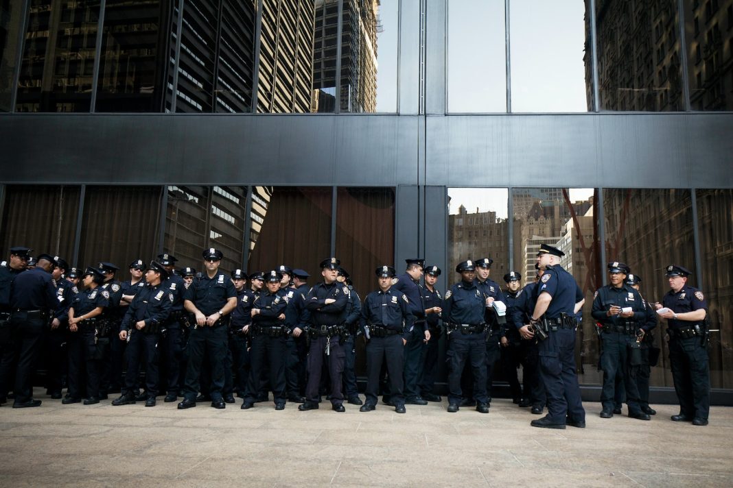 group of police standing near grey building