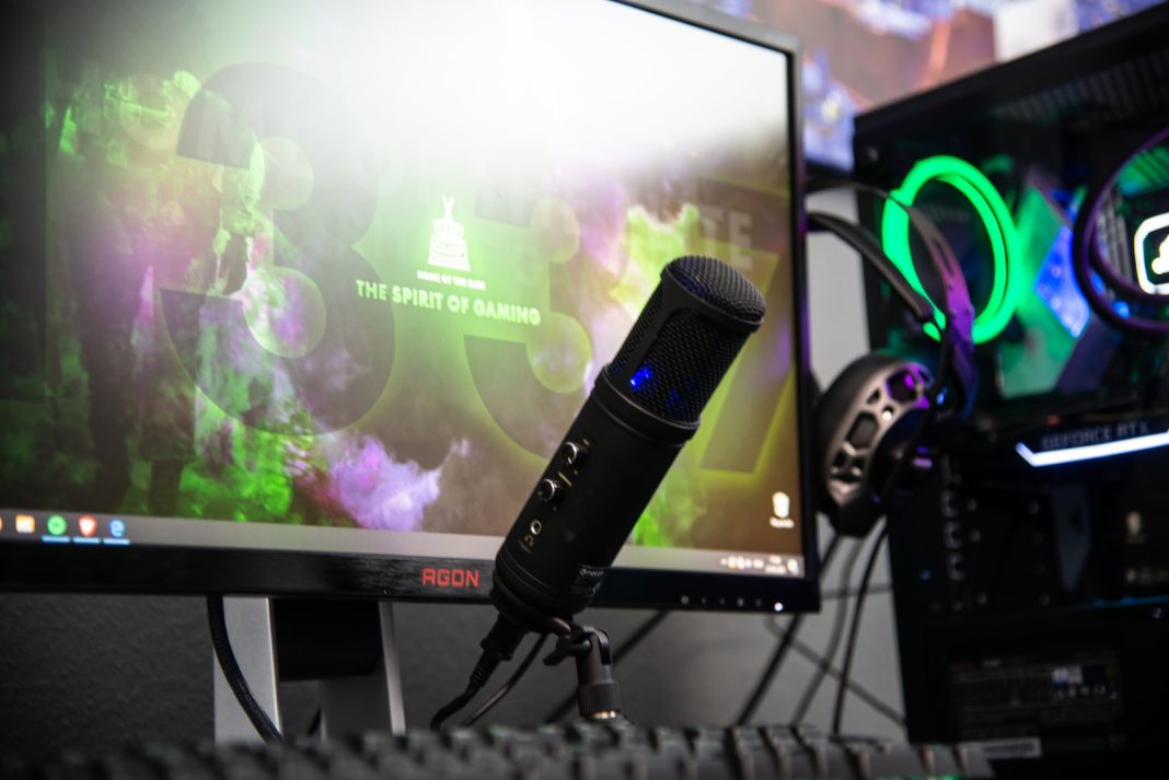 black microphone beside black flat screen computer monitor